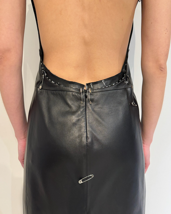 iPhone image of the back of the black Ellery dress with pins and pencil marks in fittings