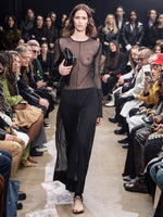Image of model walking in Proenza Schouler Fall Winter 2024 Runway Show wearing Stilsman Pant in Compact Jersey in black