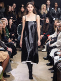 Image of model walking in Proenza Schouler Fall Winter 2024 Runway Show wearing Ivonne Dress in Polished Leather in black