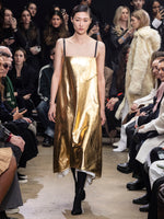 Image of model walking in Proenza Schouler Fall Winter 2024 Runway Show wearing Ivonne Dress in Polished Leather in gold