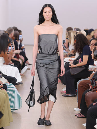 Model walking Proenza Schouler SS24 Runway in Gwen Dress In Black/white Silk Nylon, Net Sling Bag In Black Tulle, Soft Square Perforated Slippers In Black Soft Calf