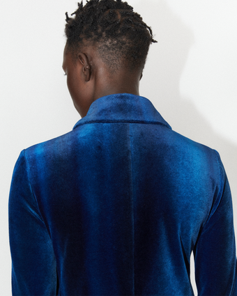 4x5 cropped image of a model facing away from the camera wearing the blue velvet ice dye shirt dress against a white background