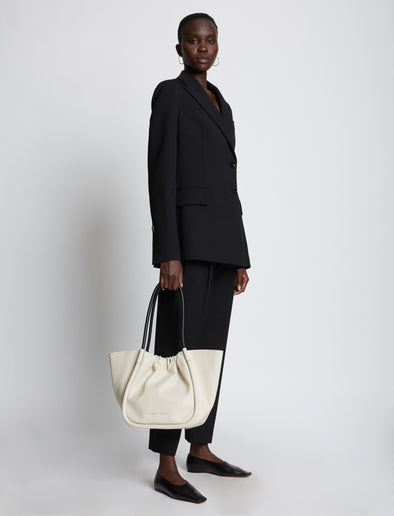 Image of model holding Large Ruched Tote in CLAY