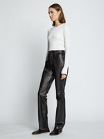 Side full length image of model wearing Leather Straight Pants in BLACK