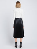 Back image of model in Faux Leather Pleated Skirt in black