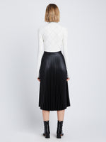 Back image of model in Faux Leather Pleated Skirt in black