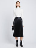 Front image of model in Faux Leather Pleated Skirt in black