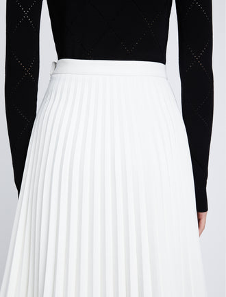 Detail image of model in Faux Leather Pleated Skirt in white