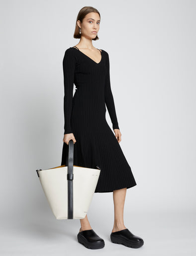 Image of model carrying Sullivan Leather Bag in VANILLA in hand