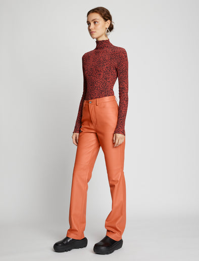 Side full length image of model wearing Leather Straight Pants in TERRACOTTA