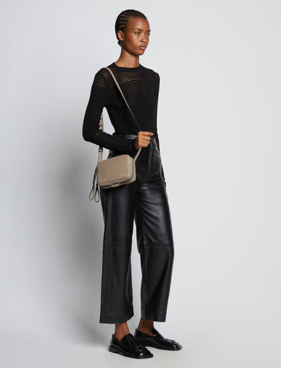 Image of model carrying Watts Leather Camera Bag in CLAY