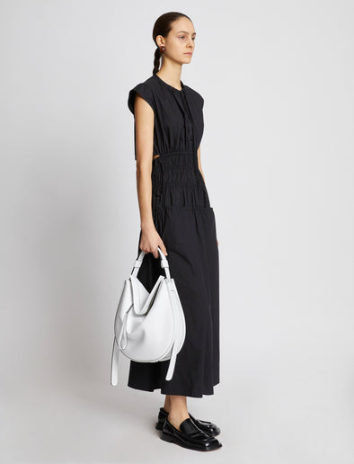 Image of model carrying Baxter Leather Bag in OPTIC WHITE on shoulder