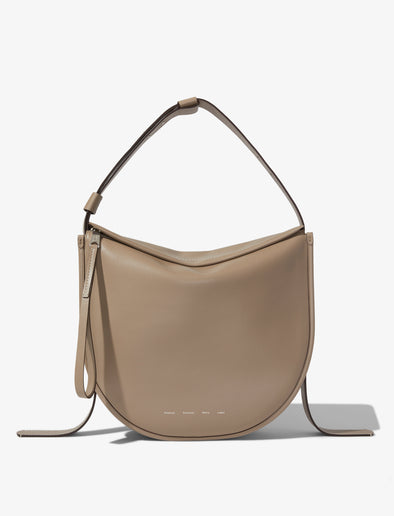 Front image of Baxter Leather Bag in CLAY with straps hanging