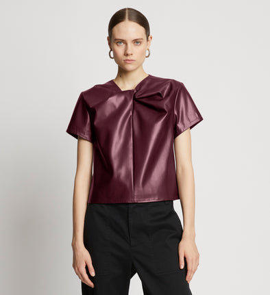 Front cropped image of model wearing Faux Leather Twisted Top in PLUM