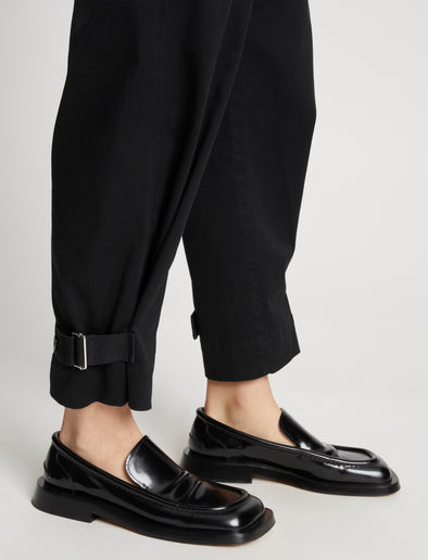 Detail image of model wearing Cotton Twill Tapered Pants in BLACK