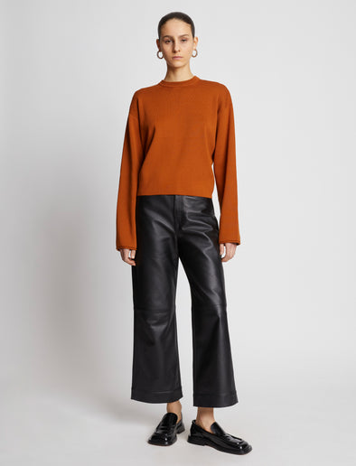 Front full length image of model wearing Twist Long Sleeve Sweater in HONEY