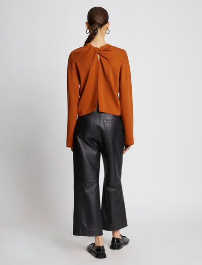 Back full length image of model wearing Twist Long Sleeve Sweater in HONEY