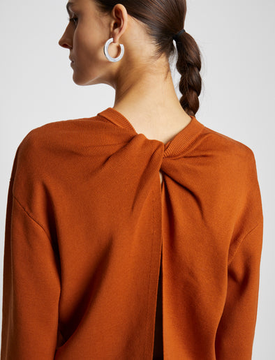 Detail image of model wearing Twist Long Sleeve Sweater in HONEY