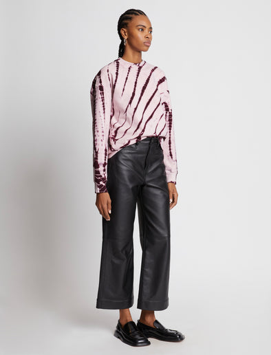 Side full length image of model wearing Tie Dye Sweatshirt in LIGHT PINK/PLUM