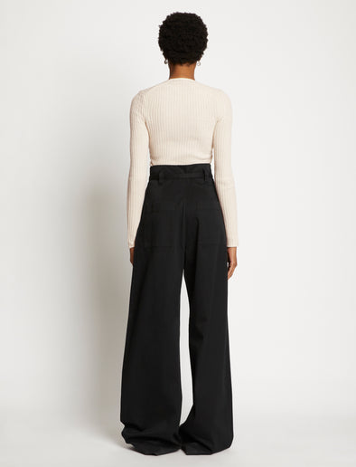 Back full length image of model wearing Plaited Rib Scoop Neck Sweater in BONE/PALE CASHEW