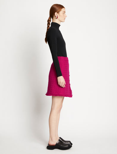 Side full length image of model wearing Tweed Mini Skirt in MAGENTA