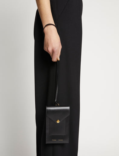 Image of model wearing Phone Case in BLACK