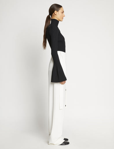 Proenza Schouler side image of model wearing Viscose Rib Zip Sweater in black