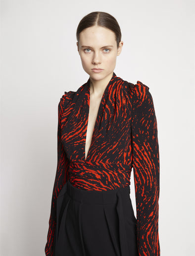 Detail image of model wearing Painted Spiral Crepe De Chine V-Neck Top in RED MULTI