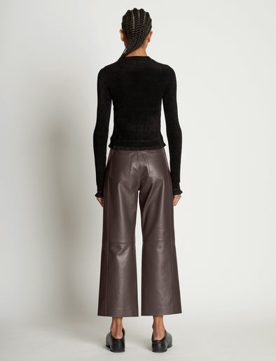 Back full length image of model wearing Cropped Turtleneck Chenille Sweater in BLACK