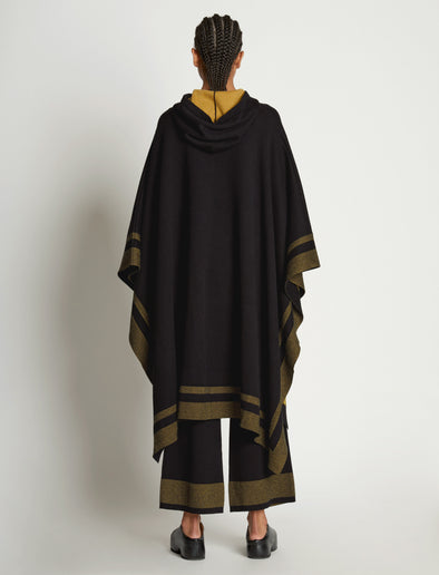 Side full length image of model wearing Cashmere Blend Poncho in BLACK/DARK SAND