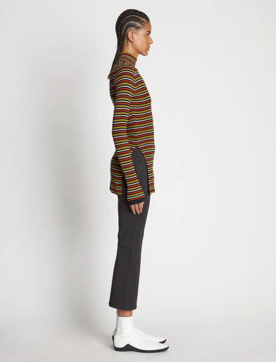 Side full length image of model wearing Stripe Knit Turtleneck in VERMILLION MULTI