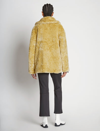 Back full length image of model wearing Faux Rabbit Peacoat in SAND