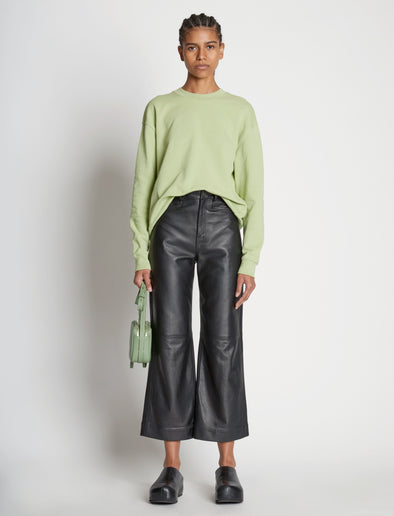 Front full length image of model wearing Long Sleeve Sweatshirt in GREEN TEA