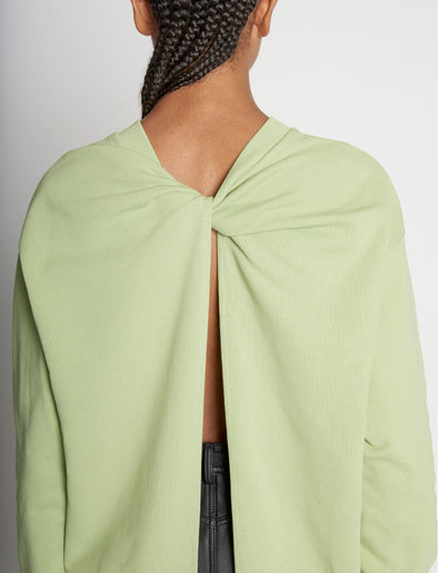 Detail image of model wearing Long Sleeve Sweatshirt in GREEN TEA