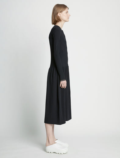 Side full length image of model wearing Rib Knit Button Front Dress in BLACK