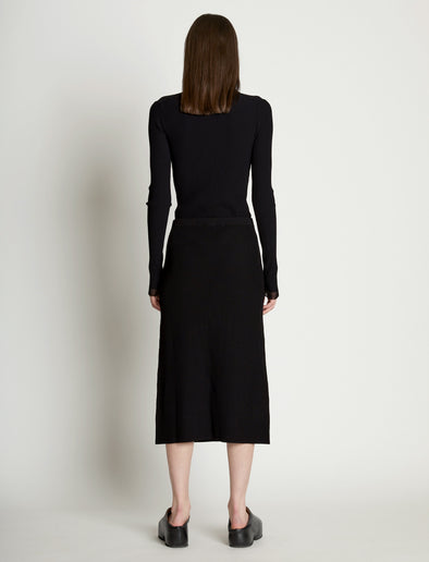 Back full length image of model wearing Rib Knit Button Front Skirt in BLACK