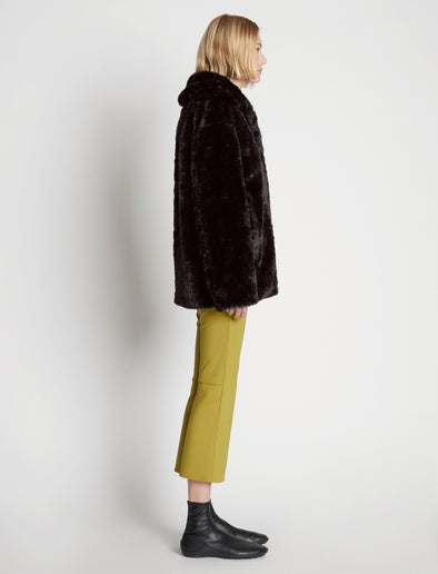 Side full length image of model wearing Faux Rabbit Peacoat in BLACK
