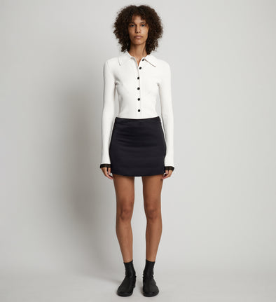 Front full length image of model wearing Satin Mini Skirt in BLACK