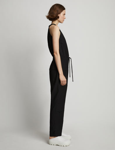 Side full length image of model wearing Drapey Suiting Tank Jumpsuit in BLACK