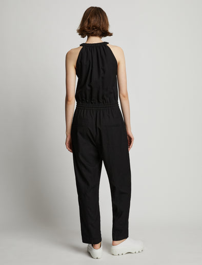 Back full length image of model wearing Drapey Suiting Tank Jumpsuit in BLACK
