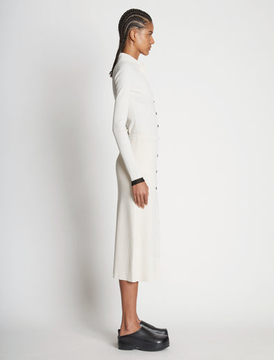 Side full length image of model wearing Rib Knit Button Front Skirt in CREAM