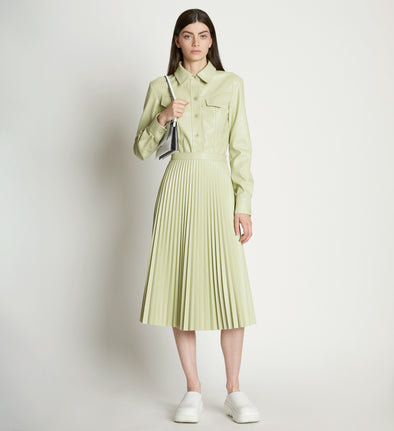 Front full length image of model wearing Faux Leather Pleated Skirt in GREEN TEA