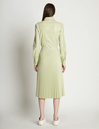 Back full length image of model wearing Faux Leather Pleated Skirt in GREEN TEA