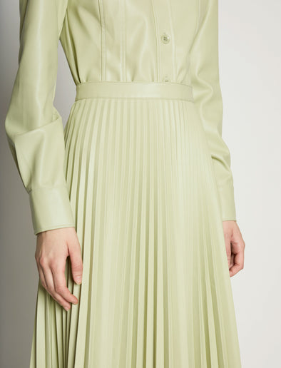 Detail image of model wearing Faux Leather Pleated Skirt in GREEN TEA