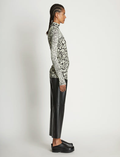 Side full length image of model wearing Mixed Floral Jersey Top in PEARL/BLACK