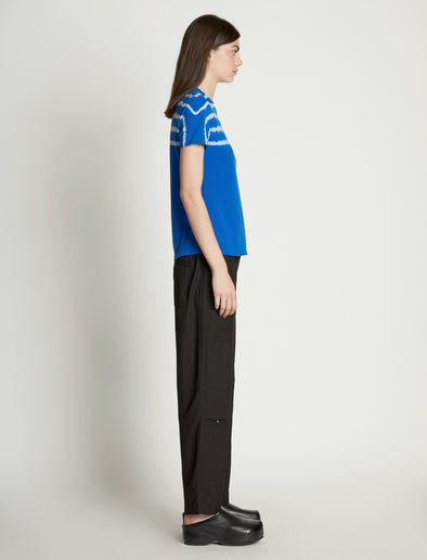 Side full length image of model wearing Tie Dye T-Shirt in BRIGHT BLUE/PERIWINKLE
