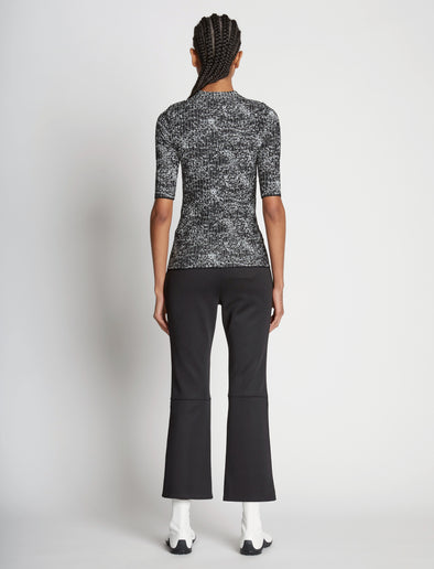 Back full length image of model wearing Speckle Knit Sweater in PEARL/BLACK