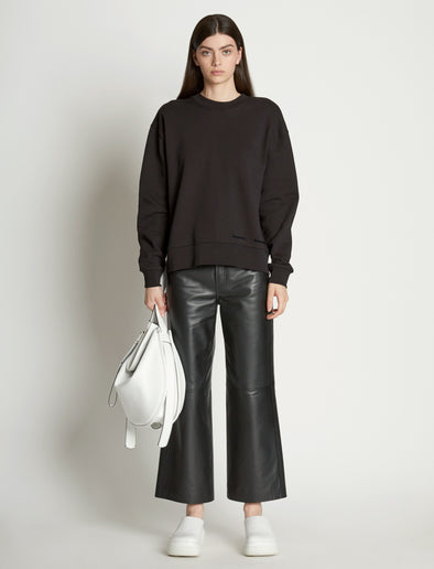 Front full length image of model wearing Long Sleeve Sweatshirt in BLACK