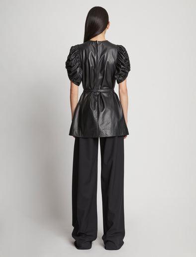 Back full length image of model wearing Leather Belted Top in BLACK