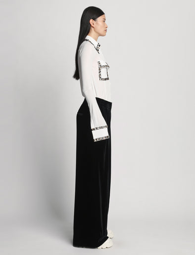 Side full length image of model wearing Silk Viscose Velvet Trouser in BLACK